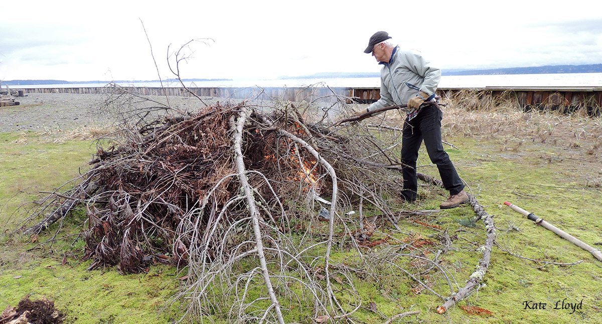 My husband tackling our burn-pile after a burn-ban last summer and fall.